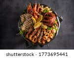 Mixed Seafood Contain Blue Crabs, Mussels, Big Shrimps, Calamari Squids and Grilled Barracuda Fish Garlic with Lemon on Dish