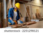 Small photo of African American carpenter man look happy to work with timber in factory workplace in concept of happiness environment for worker increase quality of work.