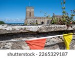 Small photo of The exterior of St Aidan's Church and churchyard in Bamburgh, with Platinum Jubilee celebrations bunting. Northumberland, UK