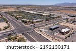 Small photo of Afternoon aerial view of new shopping mall sprawl and empty lots of downtown Goodyear, Arizona, USA.
