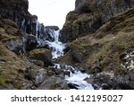 stock-photo-little-hidden-gem-frozen-waterfall-in-iceland-waterfall-from-melting-snow-and-ice-environment-1412195027.jpg