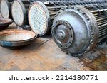 Corrosion, refinery heat exchangers chiller tubes with flange system. Row of Industrial heat exchangers or boilers with covers rusty tube sheet or tube board with deposits and corrosion.