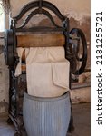 Small photo of Vintage cast iron mangle wringer machine and washing laundry dolly tub