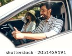 Young couple in a new car. A man driving a car with his girlfriend and having fun. Buying and renting a car. Travel, tourism, recreation.