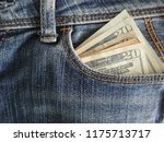 Money 20 dollars cash bank notes in denim jeans pocket.