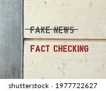 Text on wall FAKE NEWS (cross out) FACT CHECKING ,concept of protection from made-up stuff which easily viral spread online , fact checking is a must before sharing