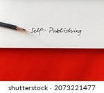 Small photo of Pencil one white paper with text SELF-PUBLISHING on copy space orange background, act of writer publish creative work book media independently at own expense without traditional publishing house