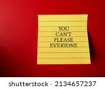 Small photo of Note on red background with text YOU CAN'T PLEASE EVERYONE - concept of PEOPLE PLEASER who tries hard to make others happy even go out of their way, time or resources,overly co with pleasing others