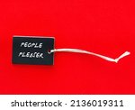 Small photo of Paper tag on red background with words PEOPLE PLEASER, means people who put someone else need ahead of their own, overly concerned with pleasing others, doing whatever it takes to make others happy