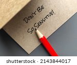 Small photo of Red pen on handwriting craft paper card Don't Be So Sensitive, a gaslighting message to accuse or emotional abuse others to question their beliefs or doubt their perceptions and become distressed