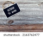 Small photo of Chalkboard on wood copy space background with handwritten text RETURN TO WORK, process of bringing employees back to workforce workplace after absence period of Covid-19 pandemic