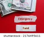 Small photo of Cash dollar money on red background with plaster band aid written EMERGENCY FUND, concept of money set aside to pay for unexpected expenses, financial safety net for future problem