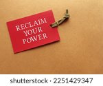 Small photo of Red tag on copy space envelope with message Reclaim Your Power, self talk affirmation to encourage tired of feeling stuck people in career or relationship, to reclaim power and reinvent life