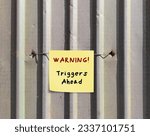 Small photo of Grey wall with stick note WARNING! triggers ahead - concept of knowing your triggers, to aware or identify emotion triggers when encountering something difficult