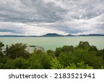Lake Balaton in Hungary under a cloudy sky. 
Viewing point is from the town of Fonyód in northwesterly direction. Characteristic volcanic hills are visible on the other side of the lake.
