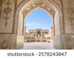 View through an arch of the buildings of the historic Agha Bozorg Mosque in Kashan, Iran. Building was built in late of 18th century