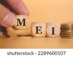 Small photo of The acronym MEI for Individual Microentrepreneur in Brazil written on wooden dice. A man's hand forming the acronym. Coins in the composition. Brazilian economy.