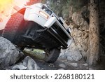 Car steering and suspension system of a 4x4 suv. Prepared Off-roader ran over a large stone lifestyle.