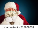 Santa: Holding Up Fanned Out Handful Of Cash