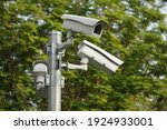 Small photo of CC.TV. cameras on metal pole in public park for monitor, observe and record evident of incident for investigation and prevent criminal. Safety, CC.TV. camera concept.