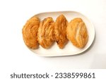 Small photo of deep fried curry puff,curry puff pastry, karipap,epok epok, spiral curry puff isolated a white backdrop . thai curry puff concept.this pastry is asian traditional snacks