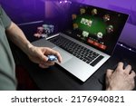 Young man play online poker in...