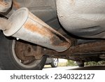 Small photo of Leaky exhaust of an old car on a chassis