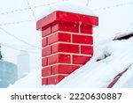 Small photo of Red smoke brick pipe, chimney close-up, on the roof of a snow-covered house. Symbol of the New Year holidays, Christmas and the arrival of Santa Claus. Snow drifts on the roof with a chimney.
