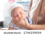 Small photo of Soft focus photo of mother, mom using hand Hold baby to help a baby newborn infant belch burping after breastfeeding milk to heal gas pain or indigestion