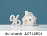Small photo of Percentage and house on white desk. mortgage calculator or real estate business concept. Listing. Down payment. Loan or insurance rate payments. Liability and risk