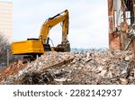 Small photo of dismantling of the building, an excavator destroys an old building. High quality photo