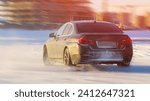 Small photo of Car at high speed moves on slippery road, icy road, drifting car in freezing weather, car skidding on icy road in frost, Drift car on ice, Auto ice racing, Tinted, Selective Focus, Sun Flare