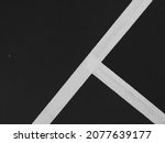 Small photo of Lines, abstract sports background or texture on outdoor sports field. Black and white lines on the sports field (black and white shooting)