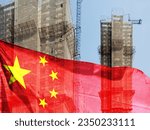 Double exposure creative hologram of unfinished supertall building and Chinese flag. Describe China's real estate collapse, bubble, financial turmoil, and China's Lehman storm