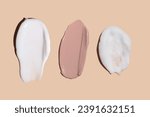 Small photo of Set of cream texture cosmetic strokes on a beige background. Skin care. Tonal cream for the face.