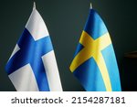 The small flags of Sweden and Finland.