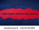 Temporary protected status inscription on red sheet and a torn piece of paper.