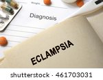 Small photo of Page with word eclampsia and glasses. Medical concept.