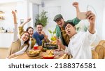 Small photo of Group of Cheerful Asian man and woman friends enjoy dinner party using mobile phone taking selfie together at home. Happy male and female reunion meeting and celebrating on holiday event vacation.