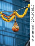 Small photo of photograph of traditional dahi handi or Matka (earthen pot) tied up high on the Gokulashtami festival which is Lord Shri Krishna's birthday. Indian youth form a human pyramid to break the Dahi Handi