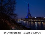 View along the Seine with Eiffel tower dressed in European flag lighting for the French presidency