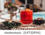 Small photo of Negroni at poolside. Classic cocktail Negroni with gin, campari and martini rosso. Traditional recipe