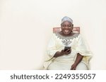 Small photo of overexcited black african american senior woman holding her smartphone watching video online