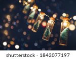 Close-up, Elegant Christmas tree in glass jar with bokeh lights background, copy space. Christmas and new year concept.