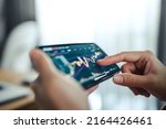 Closeup - Woman is checking Bitcoin price chart on digital exchange on mobile smartphone, cryptocurrency future price action prediction.
