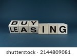 Small photo of Leasing vs buy. Cubes form the choice words leasing or buying. Concept for own property versus borrow it