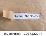Uncover The Benefits text on brown envelope. Word Uncover The Benefits on torn paper. Concept Image.