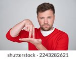 Small photo of man showing two fingers on his palm, gesture meaning go by foot, afoot.