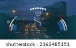 Small photo of Image of speedometer, gps and charge data on interface, over sped up city traffic at night. transport and technology, engineering design and digital interface concept digitally generated image.