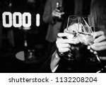 People toasting with a glass of champagne in a NYE party